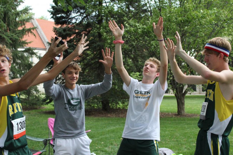 Sophomores Evan Liewer,  Josh Arend, and Simon Kerr have some fun with junior Andrew Swanson before their races.
