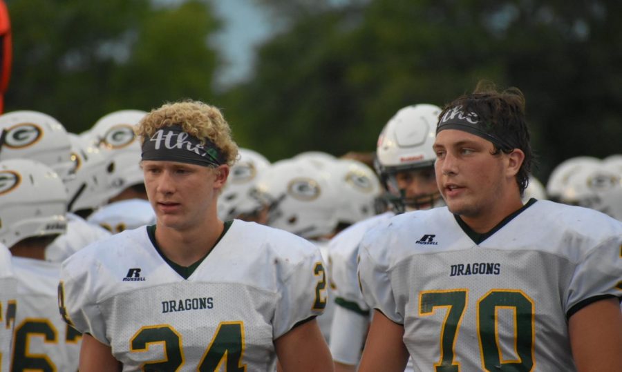 Varsity football players, junior Colby Scholl and senior Benjamin Jacobson, wearing 4the4 headbands in honor of the four girls. 