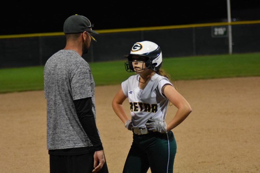 Senior Alyssa Morbach gets talked to by her coach by third base. 