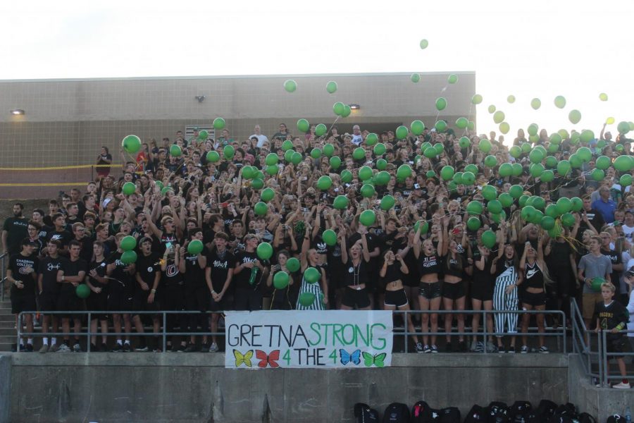 The student section released green balloons at the start of the game to show Gretna Strong. 