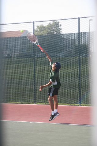 Junior Micah Bernal plays for varsity during the home game against Papillion La Vista High School. Bernal was the number one singles player this year. 