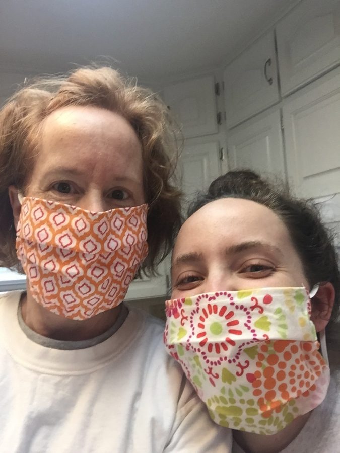 Mother and Daughter: Mrs. Rhodes and her daughter, Lauren wear their masks as they prepare to go for their weekly grocery shopping trip. They made the masks from the material that used to be on the bulletin boards in Mrs. Rhodes classroom.