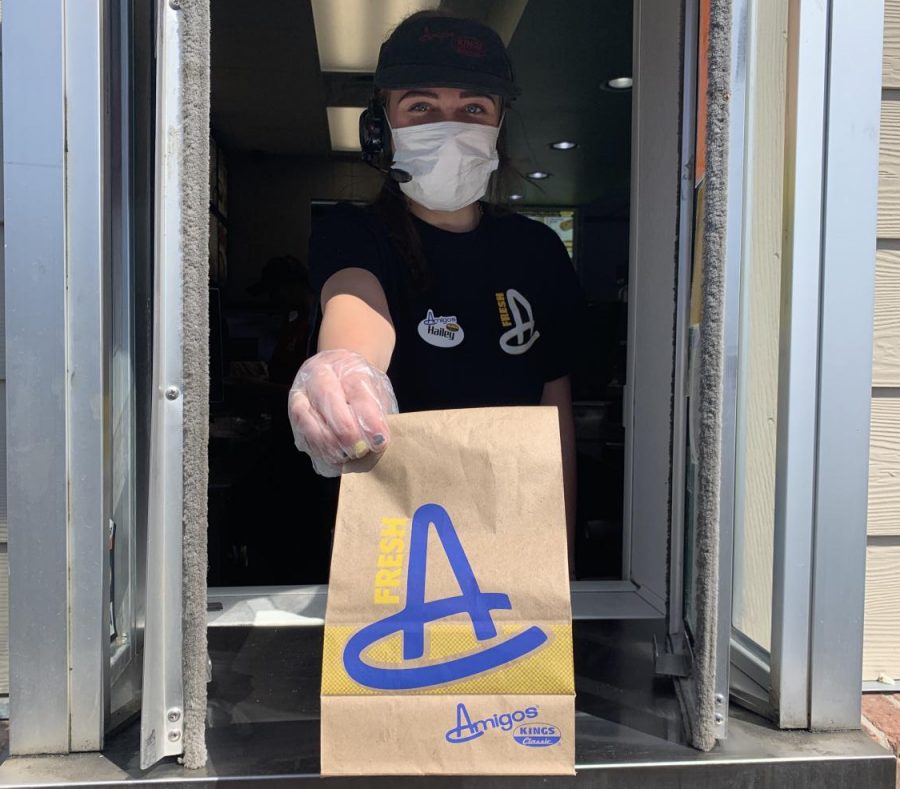 Staying+Protected%3A+When+interacting+with+customers%2C+Hailey+Wojtas+%2822%29+keeps+herself+protected+by+wearing+gloves+and+a+mask.+Everyone+must+wear+gloves+and+a+mask+when+working+in+drive-thru%2C+Wojtas+said.+Honestly%2C+I+feel+safer+when+I+wear+this+equipment.+I+feel+like+I+am+able+to+keep+both+the+customers+and+myself+safe.+All+drive-thru+employees+across+that+state+have+been+wearing+this+equipment+to+prevent+the+spread+of+COVID-19.