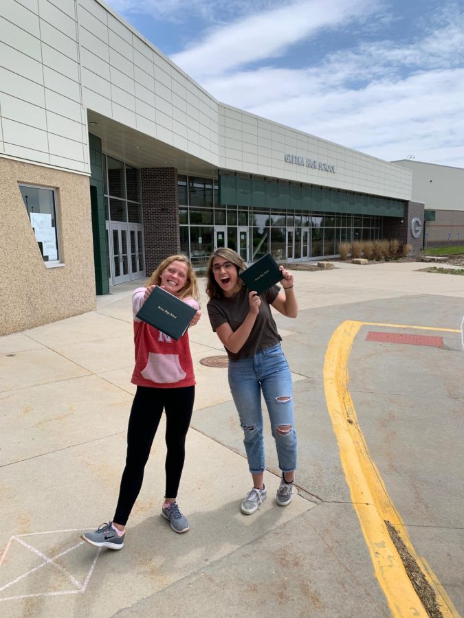 Seniors Jada Scharff (left) and Peyton Plugge (right) holding their diplomas in front of Gretna High School on May 12 one of the senior sign out days.