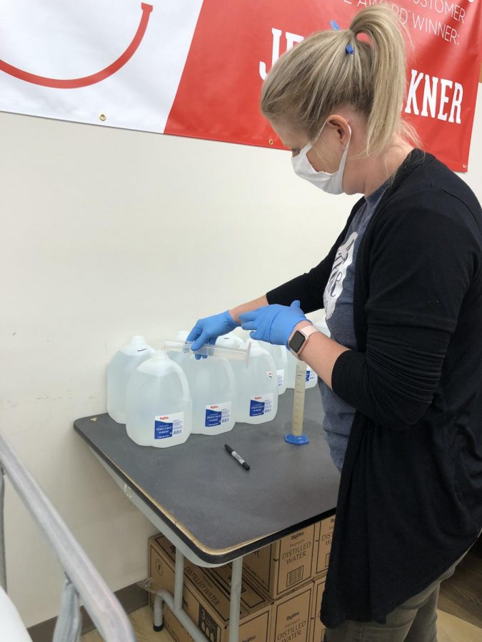 Amy Adams mixing together the chemicals for the hand sanitizer.