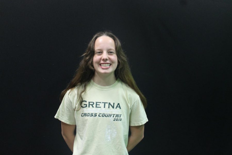 Team Designed: Member of the XC Cross Country team, Grace Pemberton (22) wears a t-shirt designed in 2019 by graduate student Kellen McLaughlin and assistant coach Ms. Jessa Sughroue. This year, cross country members wore this shirt for every meet.
