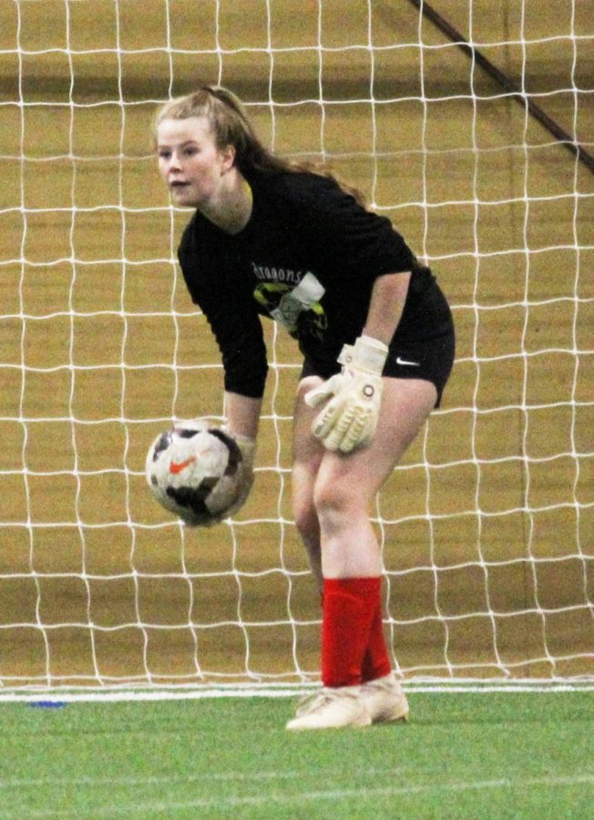 RED HOT Goalkeeper Kelsey Johnson (21) holds the ball, waiting for her teammates to get open. I am most excited for being with everyone and practicing together, Johnson said. Its such a fun environment to be around and everyone gets along well with each other. Johnson prepared for the season with her own club team and goalkeeper training.