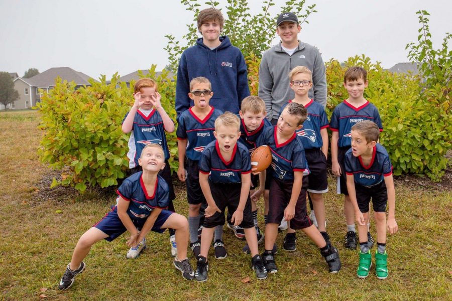 Team+Spirit%3A+The+Patriots+coached+by+Colton+Munn+%2821%29+and+Kaden+Conrad+%2821%29+pose+for+a+silly+picture.+I+would+highly+recommend+coaching+flag+football%2C+Conrad+said.+Because+it+gives+us+an+opportunity+to+teach+kids+the+game+of+football+while+also+letting+them+have+fun+doing+it.+The+team+finished+the+season+with+a+record+of+3-5.