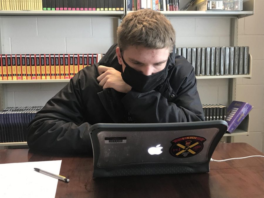 Keen Eye: Staring intently at his laptop, Ethan Wegner (22) completes the Science quiz. “I think they did very well at the scrimmage, though it is hard to judge their standing using the scrimmage,” Mr. Arch said. This is Wegner’s first time competing in Academic Decathlon.