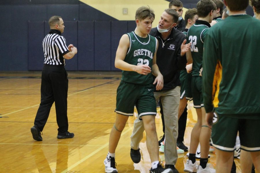 Teaching Moment: After calling a timeout, Coach Brad Feeken seeks out starting point guard Landon Pokorski (24). Coach [Feeken] has really helped me with confidence and learning, which has helped me and the team a lot this year, Pokorski said. Teaching opportunities likes these are crucial to the development of young players.