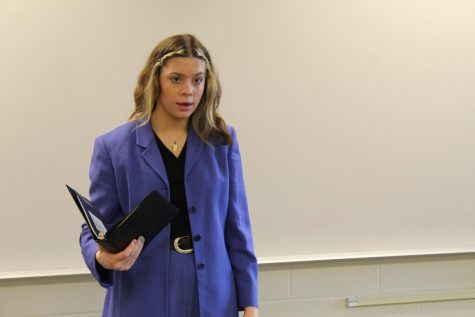 Emotional Delivery Book raised, Chloe Irwin (22) performs her Program Oral Interpretation. The topic she chose was the five stages of grief. That was the first year POI was offered in Class A.