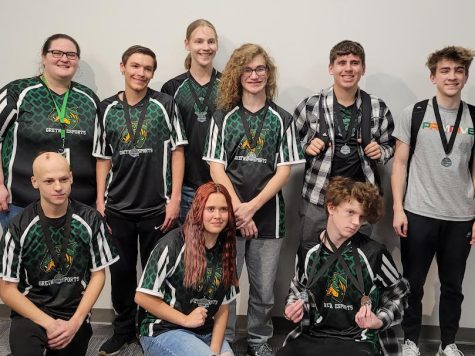 State Smiles: With jerseys on and medals around their necks, the team smiles after the state competition. we are very fortunate to have several good esports teams, esports coach Kimberly Ingraham-Beck said. This year the varsity team placed second, which im very happy about. The team performed better than last year as well as improved their skills as a whole.