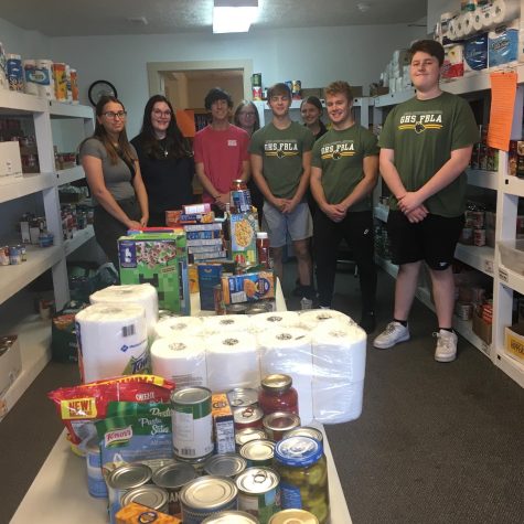 Helping the community! Members of the Gretna FBLA program (left to right), Mackenzie Grant (24), Taryn Nord (24), Joe Stolinski (24), Molly Raines (23), Shawn Davis (24), Jenna Keasling (23), Isaiah Weber (24), Jack Lowry (23) volunteer at Gretna Neighbors Food Drive. FBLA offers opportunities to students and gives them chances to become more involved.