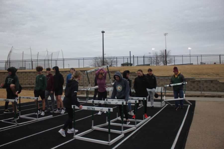 RETURNING THE FAVOR - Students help the coaches by putting the hurdles away at the end of the practice.