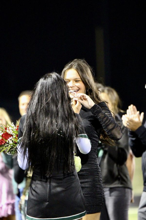 Homecoming princess, Abby Turpen (23) is handed the crown by Zoey Tucker (23). 