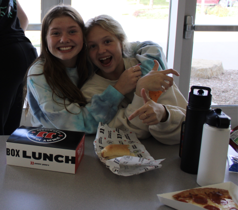 FOOD and FUN - Carley Feldhacker (25) and Preslie Tuma (25) enjoy their approved lunches dropped off by their parents. Their lunches were dropped off during second lunch.