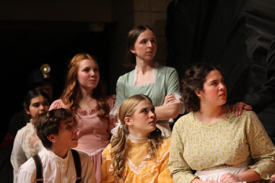 Ava Fink (26), Gabrielle Ochsner (23), Colton Knott (25), Isabel Kinnan (23) and Maya Huber (24) all react to the rally taking place in Stone Creek Sorrow, the GHS one act production.