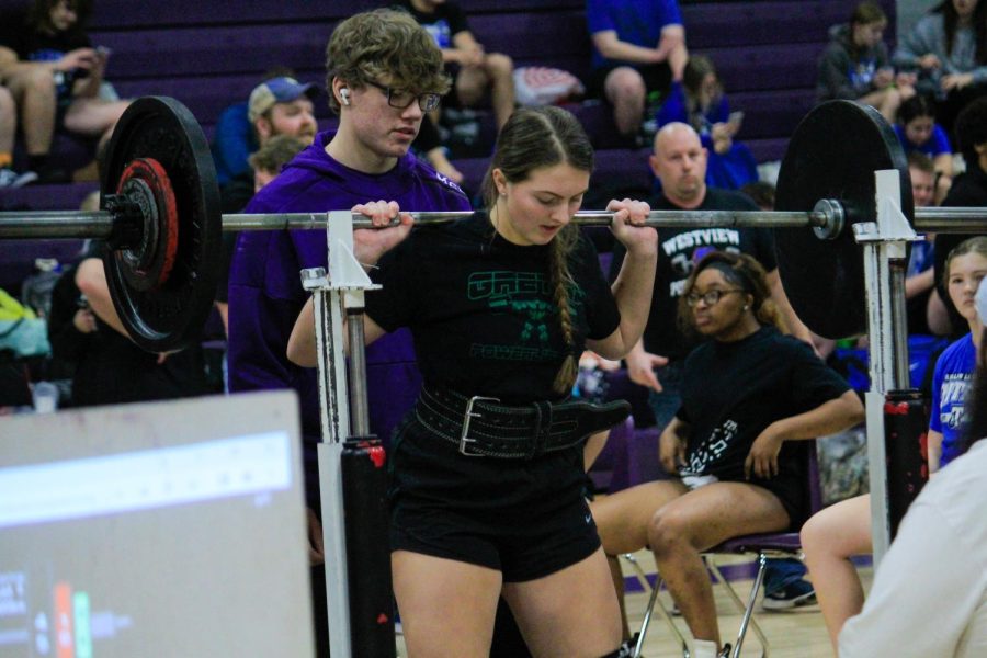 Jenna Keasling (25) prepares to lift her barbell for the squat event during a meet. 