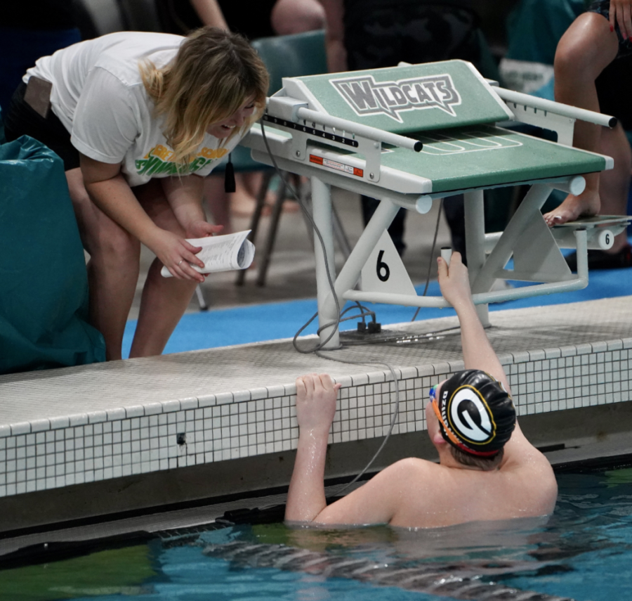 Coach+Allison+Hall+talks+with+Owen+Dziurawiec+after+his+50-meter+freestyle.+