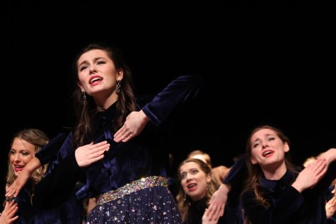 Brenna Herrold (23) dances and sing s during the ipening number of Revolutions Starry Night.