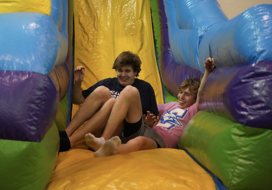 Spencer Ward (23) and Jace Erdkamp (24) run into each other at the end of the inflatable slide. The slide was one of several activities at Post Prom.