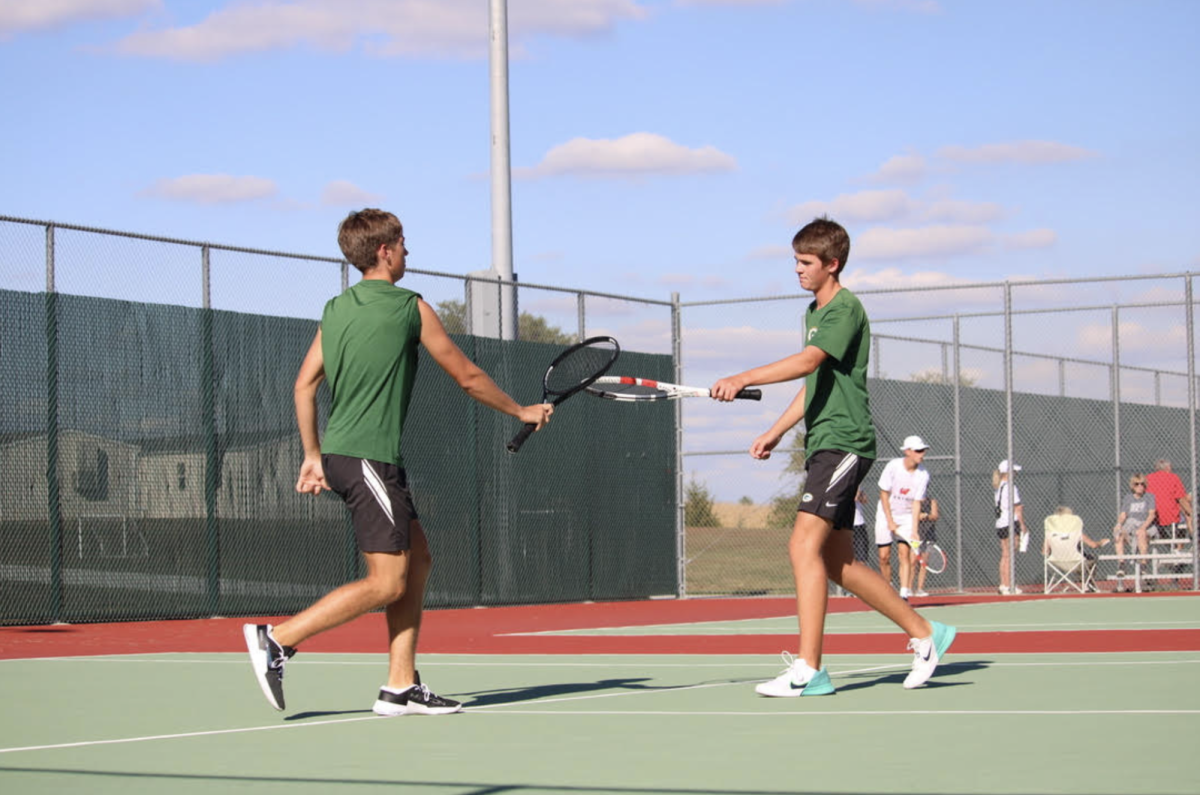 The brother duo of Emmitt (25) and Owen (26) Dickes celebrate as they score in the home game vs Westside on Sept. 26. The boys tennis season recently ended.  
