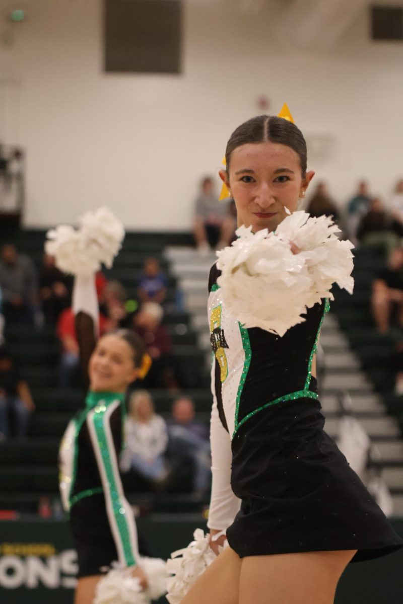 Sophomore Brooke Hamele performs with the Gretna Dance team at a recent basketball game. 