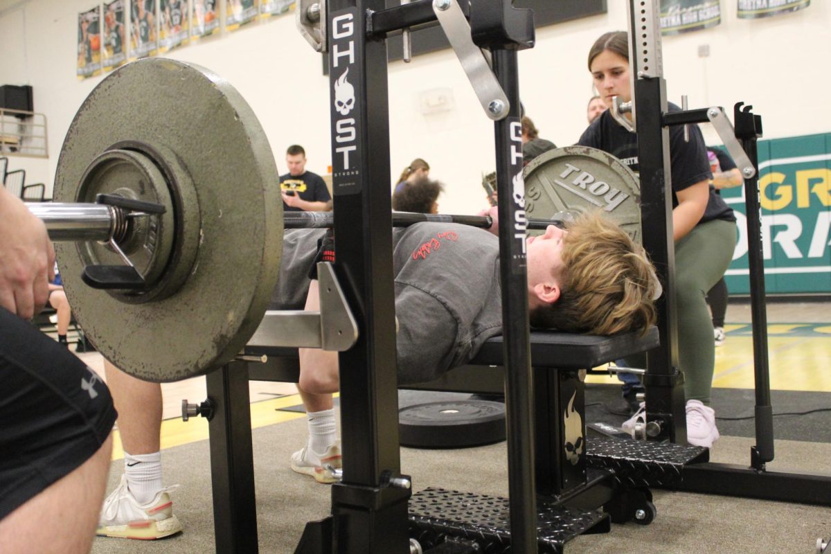 Freshman Ronan Connolly lushes up the bar during the bench press.