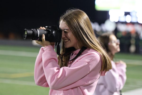 Current junior Mia Yungtum shoots photos at a 2022 football game. GHS Journalism includes online journalism and yearbook classes. 