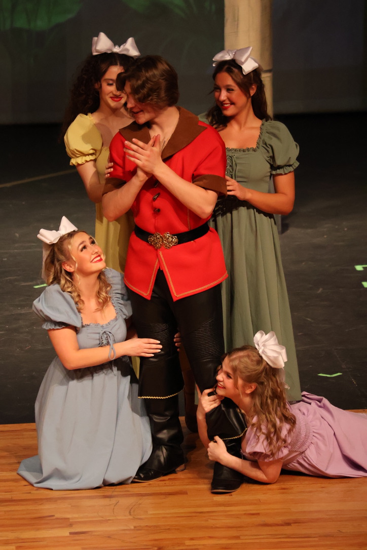 Senior Grant Pilant prepares to tell the four girls (juniors Claire Miller and Hannah Boldt and seniors Julia Lewis and Gia Lacey) that he is going to propose to Belle.