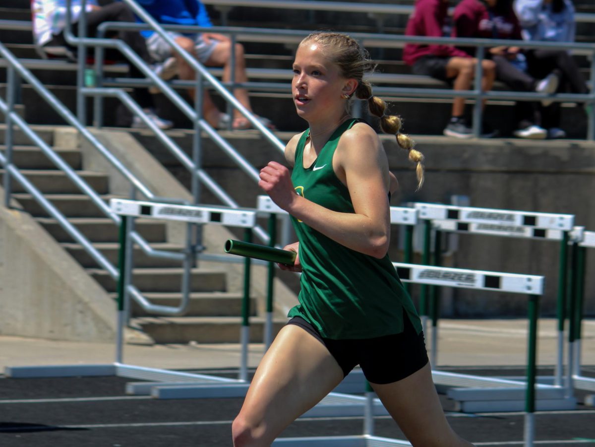 Lucy Zabloudil (27) runs in the girls 4x800m relay at the A-1 District Track Meet on May 7. They placed first overall with a time of 10:01.75.