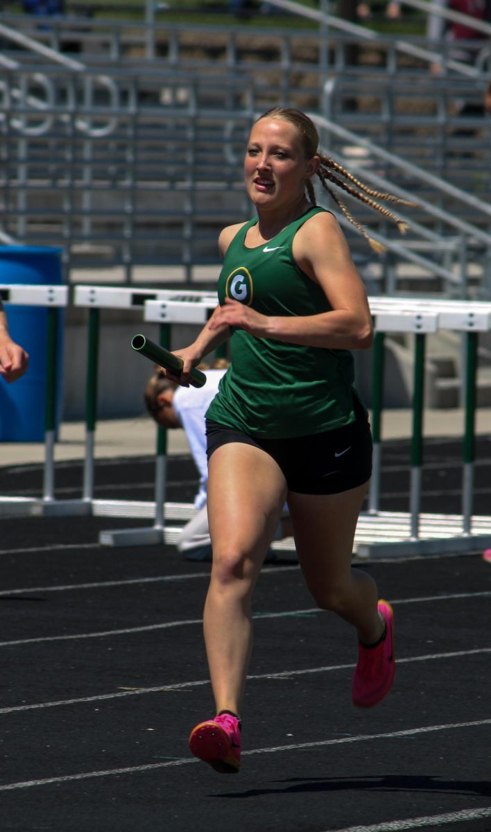 Kelsey VanWaart (26) runs in the girls 4x800m relay at the A-1 District Track Meet on May 7. They placed first overall with a time of 10:01.75.