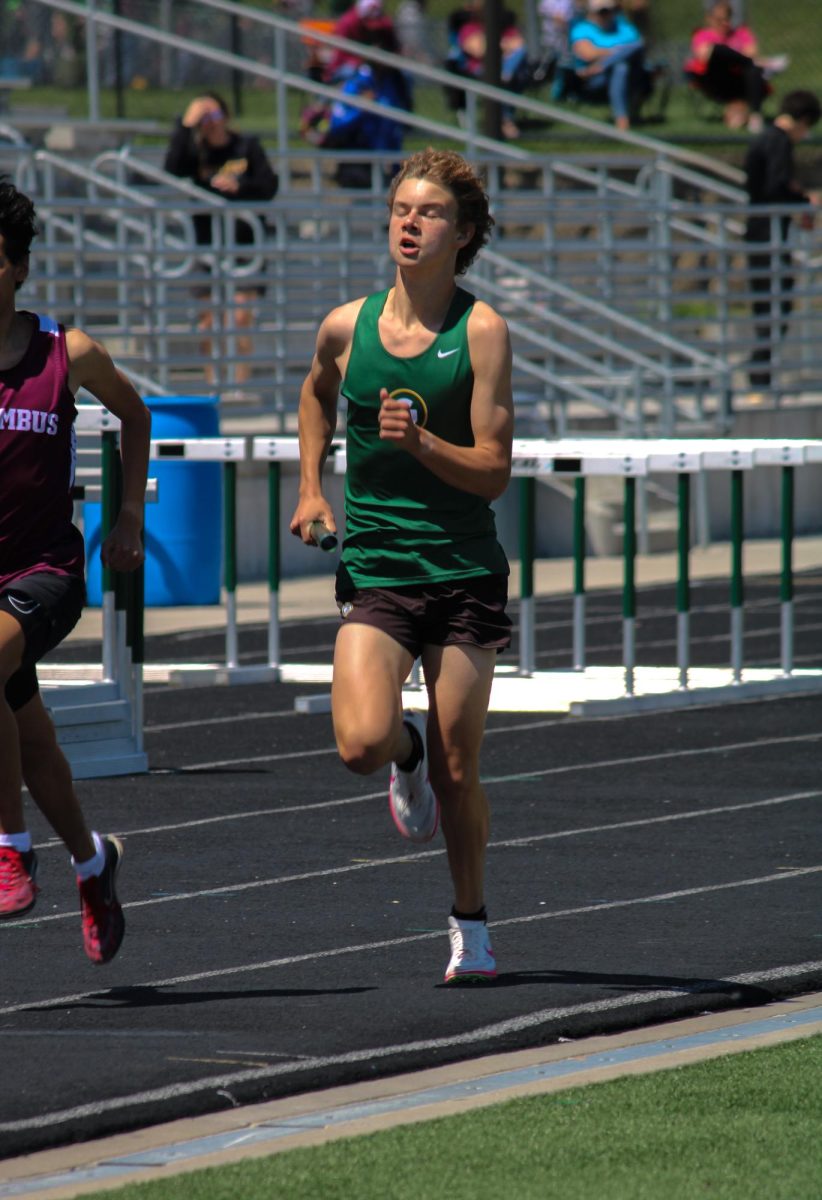 Caleb Larsen (26) runs in the boys 4x800m relay at the A-1 District Track Meet on May 7. They placed fifth with a time of 8:20.62.