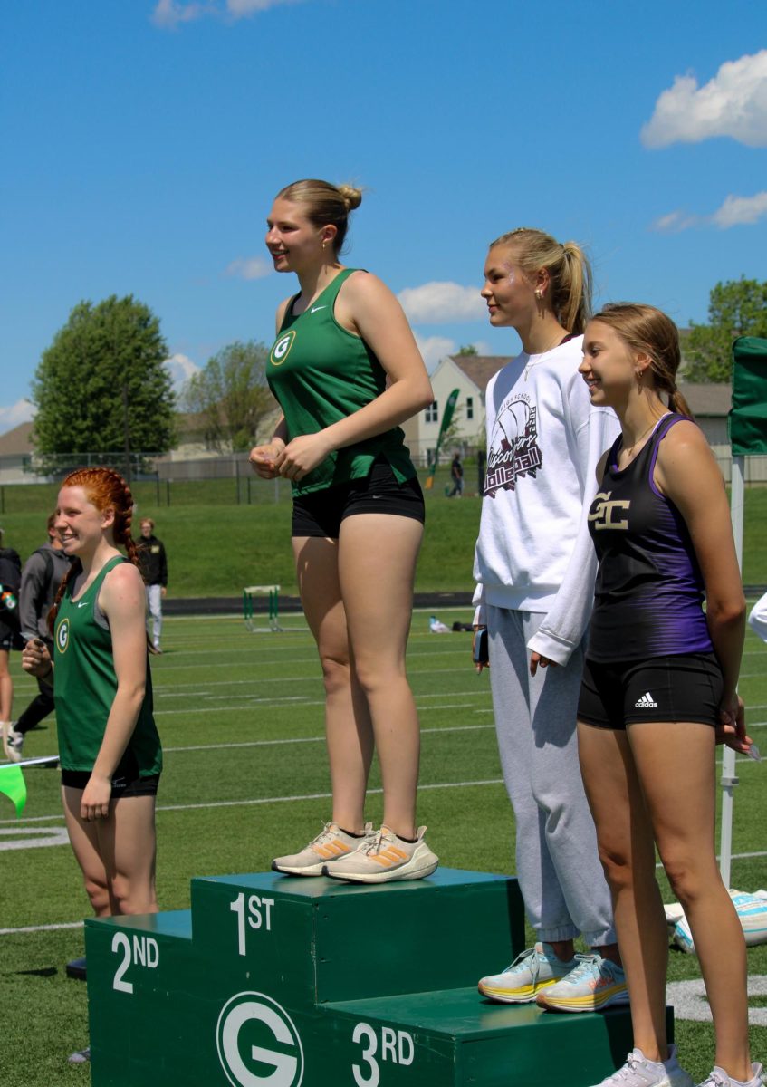 Elle Heckenlively accepts her first place medal in High Jump at the A-1 District Track Meet on May 7. She jumped for 5 4.