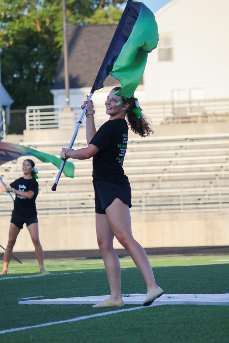 Elizabeth Wegner (27) smiles during her performance with the GHS color guard. They performed their show for this year, "Gusto Italiano: A Taste of Italy," at their expo on August 6.