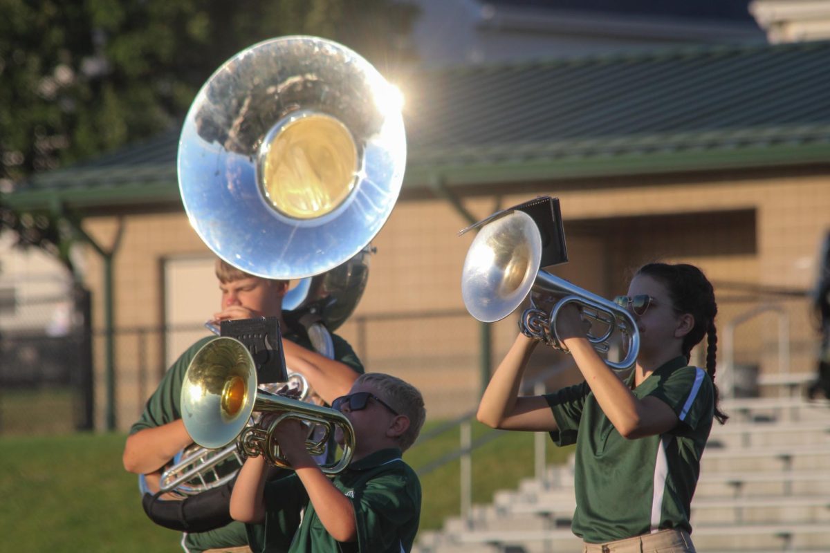 Marching band members Gideon Critchfield (28) and Charlotte Cullison (27) play their mellophones as they march alongside other members on the GHS football field. They performed their show for this year, "Gusto Italiano: A Taste of Italy," at their expo on August 6.