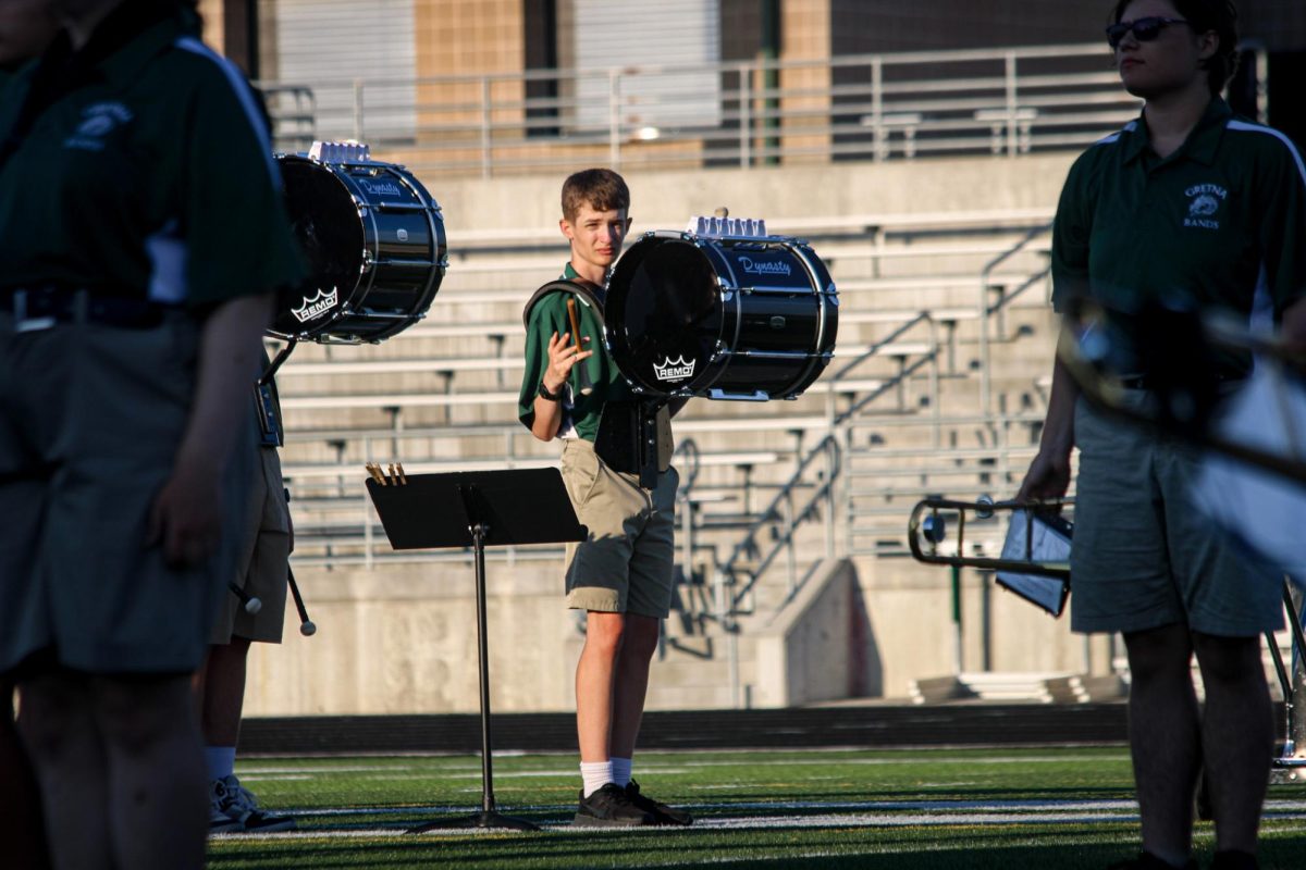 Percussion member Tony Halmes (28) spins his drum stick while waiting to perform with other members of the GHS marching band on the football field. They performed their show for this year, "Gusto Italiano: A Taste of Italy," at their expo on August 6.