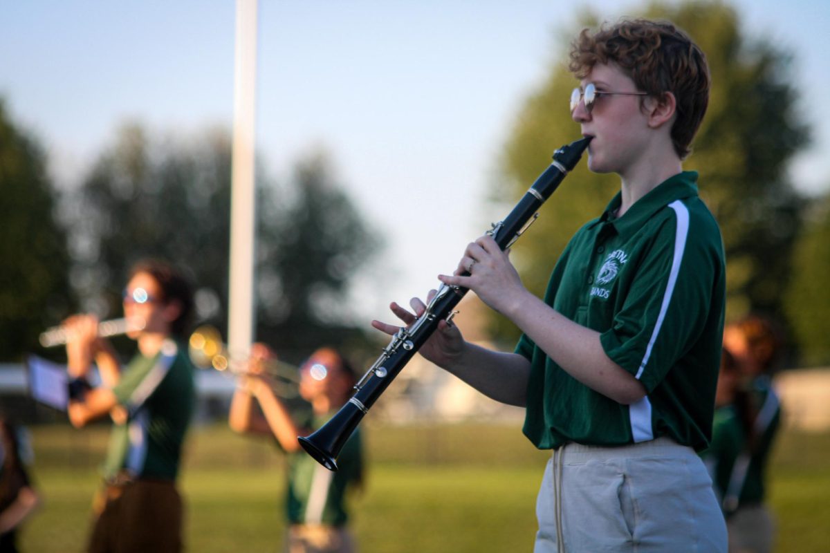 Clarinet player, Fawkes Marcheck (26), marches in place alongside other members of the GHS marching band on the football field. They performed their show for this year, "Gusto Italiano: A Taste of Italy," at their expo on August 6.