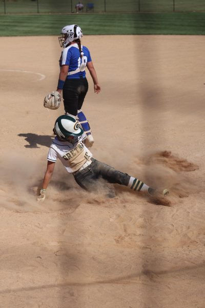 Senior Anniston Trevarrow slides into home base with a cloud of dust shrouding her. 