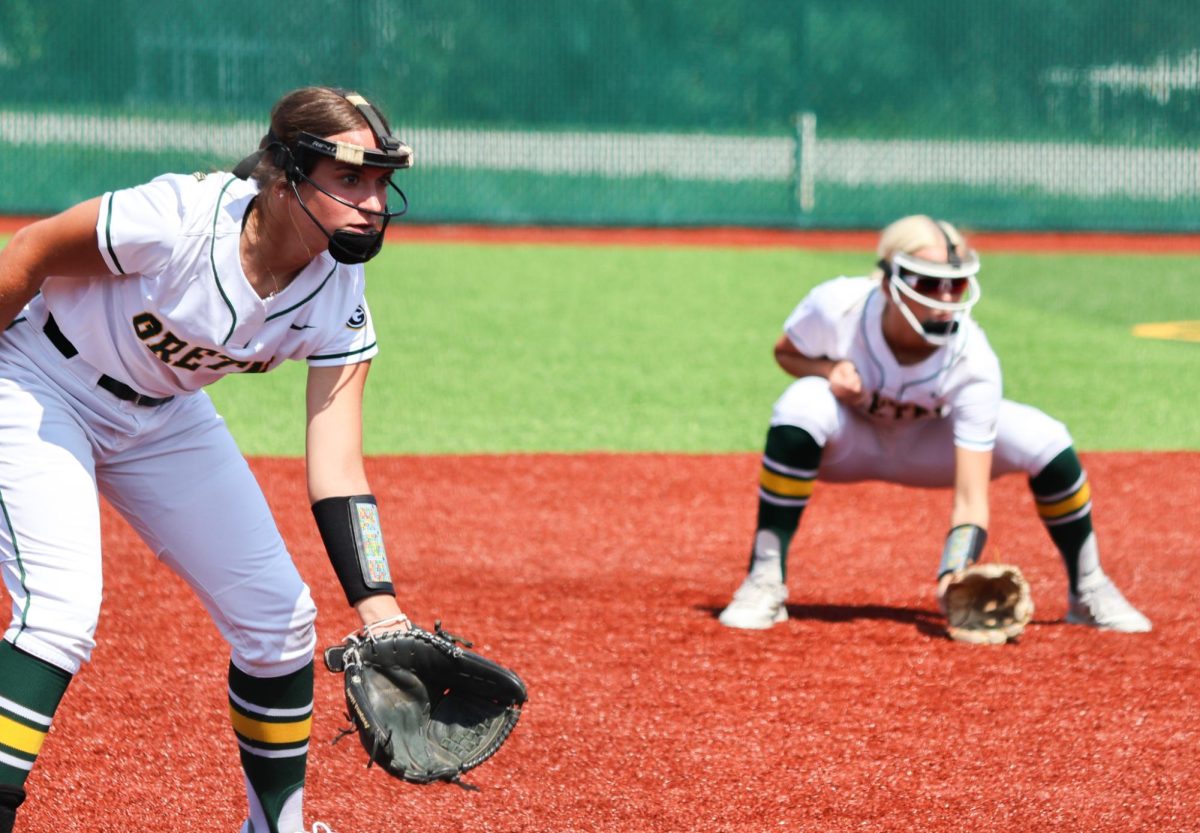 Lily Rowe (25) and Skarlett Jones (25) zone in on the batter before the pitch in the Gretna vs. Omaha Marian scrimmage on Aug. 17.