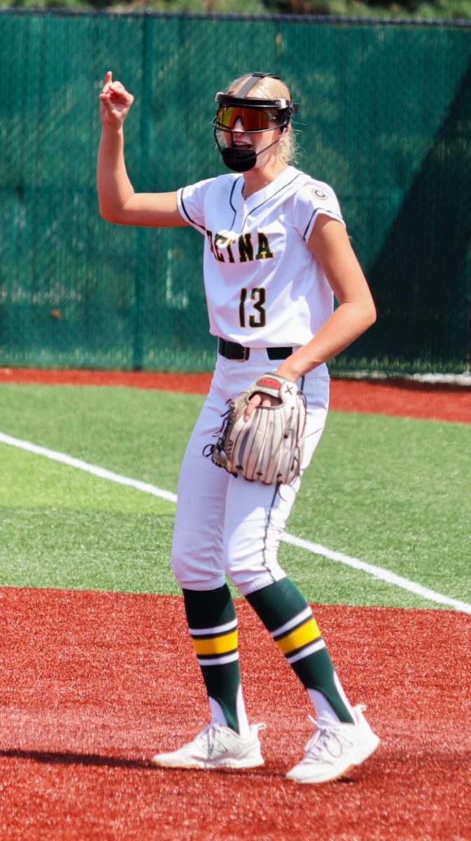 First baseman Emerson Johnson (26) communicates two outs with the rest of the GHS softball team at the Gretna vs. Omaha Marian scrimmage on Aug. 17.