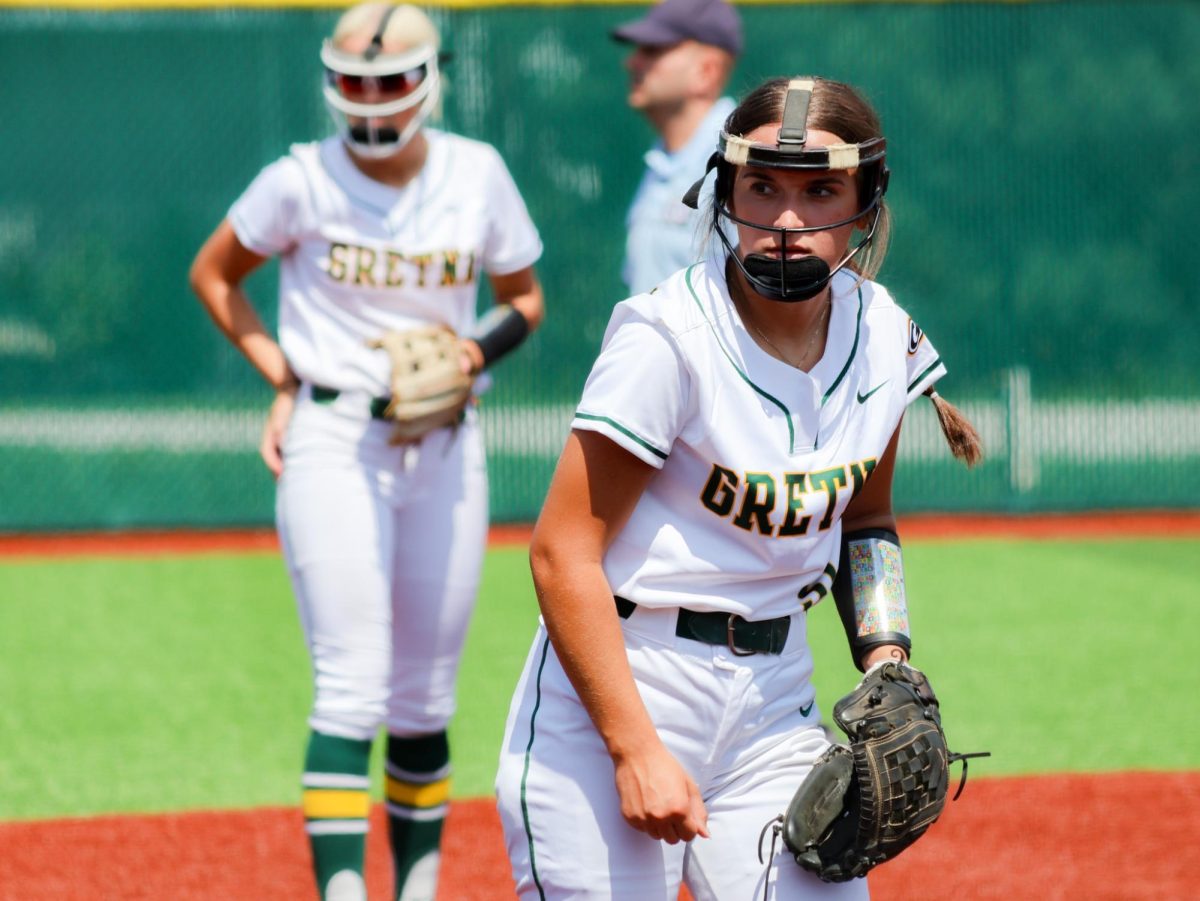 Shortstop Skarlett Jones (25) and third baseman Lily Rowe (25) ready themselves for the next play at the Gretna vs. Omaha Marian scrimmage on Aug. 17.