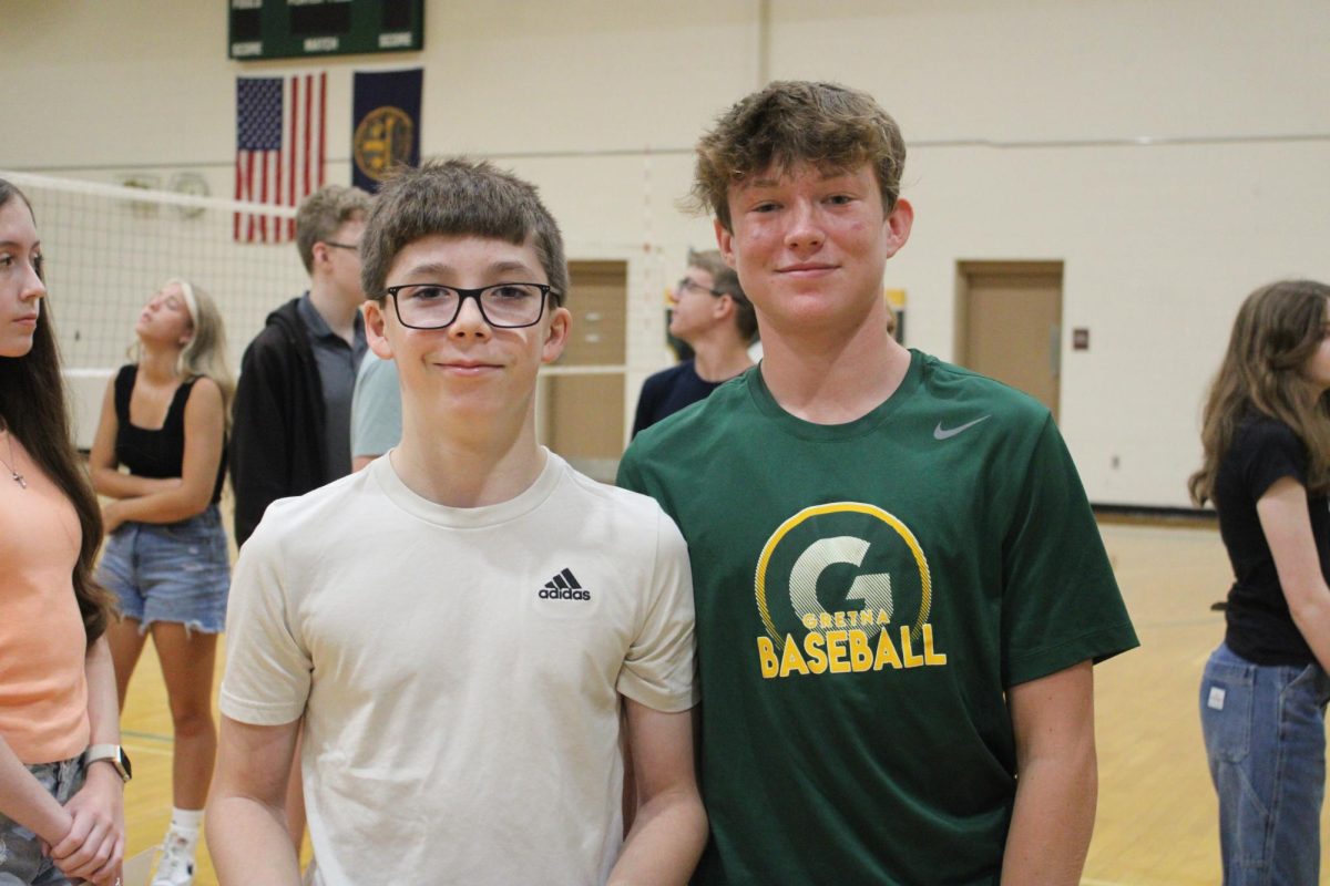 Ian Birch (28) and Brady O'Flynn (28) smile for a photo in the Auxiliary Gymnasium while waiting in line to have their yearbook pictures taken at Freshmen Day on Tuesday, Aug. 13.