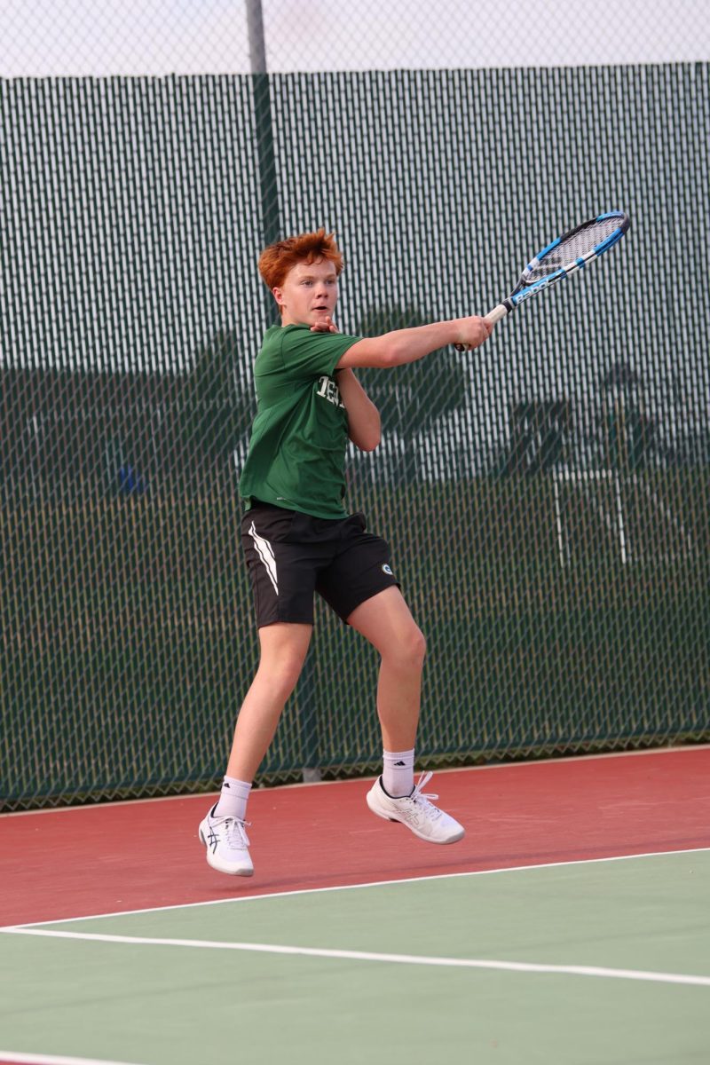 Freshman Joey Onwhiler finishes his forehand with top spin. 