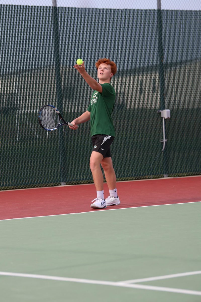 Freshman Joey Onwhiler starts his serve off strong with a arching throw into the air.