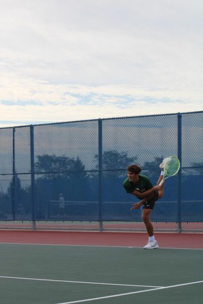 Senior Holden Dodson finishes off his serve with power. 