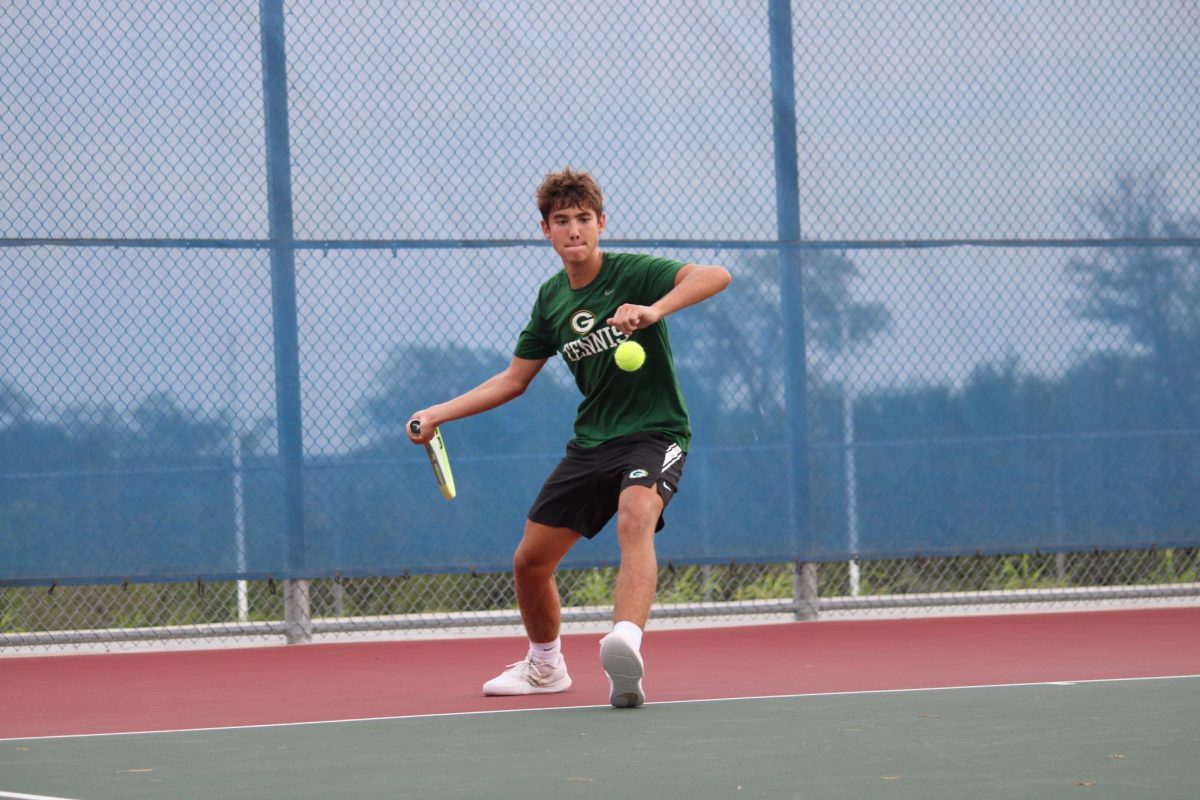 Senior Holden Dodson brings his racket back for more power in his forehand. 