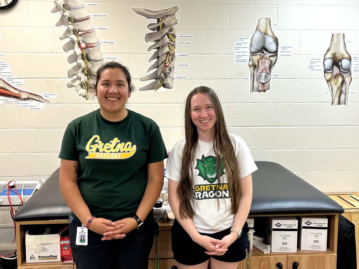 The GHS athletic trainers Katia Lira Garcia (left) and Logan Weis (right) pose for a picture in the athletic training room.