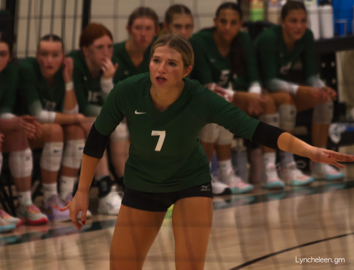 Senior Elle Heckenlively talks to her teammates before the play.