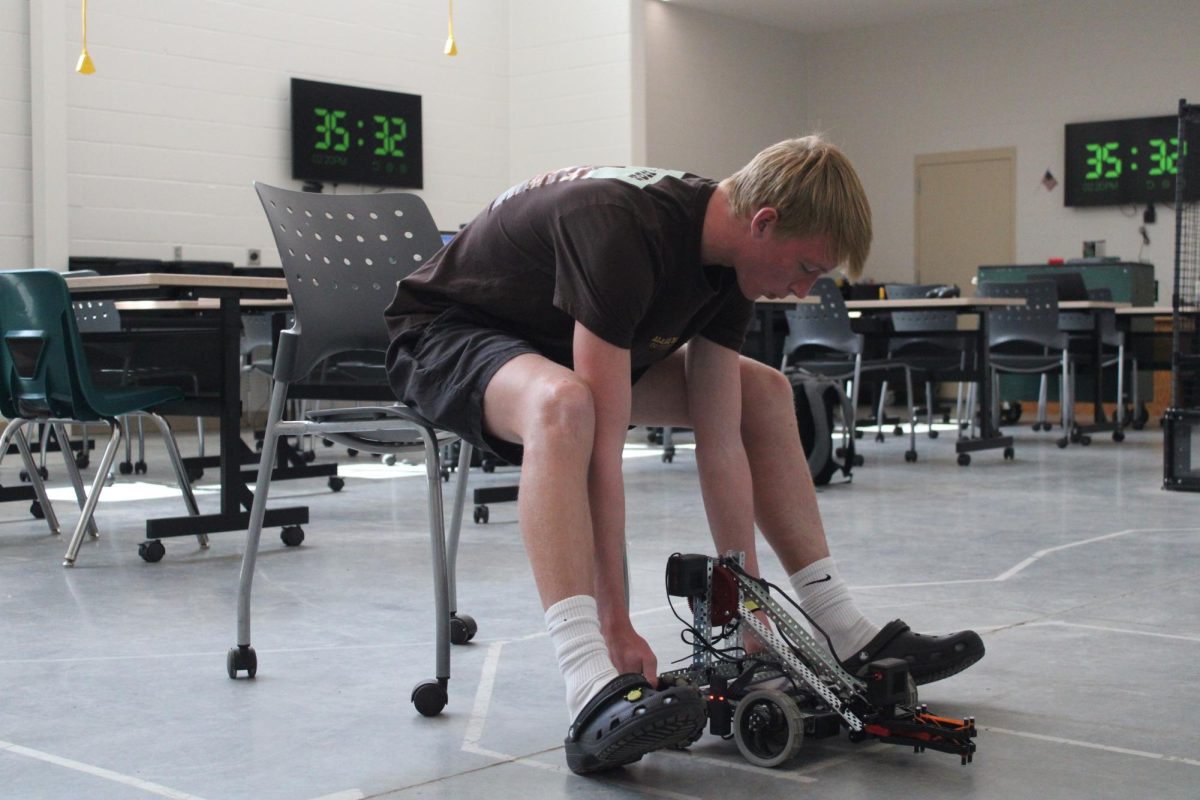 Junior Miles Cradduck works with his robot Adam Schwaninger's classroom, which is nicknamed "the lab." The class' robots are made by Bex Robotics. 